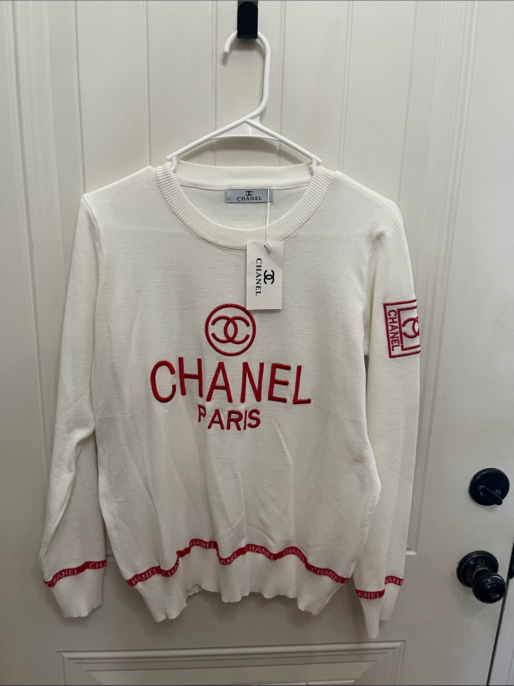Source Unknown White Crewneck Sweater with Red Chanel Logo